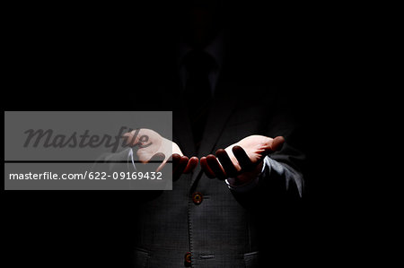 Male hands on black background