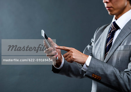 Japanese businessman against grey background