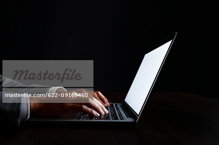 Male hands working on laptop