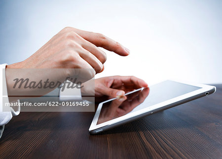 Male hands working on tablet