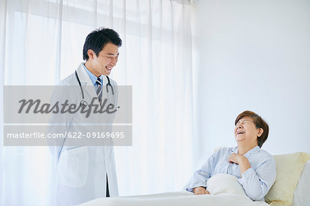 Japanese doctor with a patient in bed