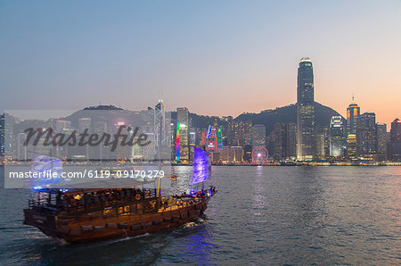 Junk boat in Victoria Harbour at dusk, Hong Kong Island, Hong Kong, China, Asia