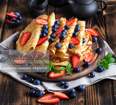 Healthy vegan pancakes crepe with blueberry and strawberry.