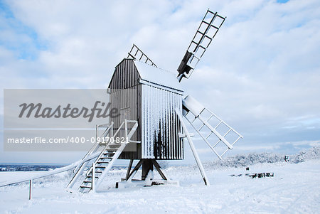 Snow covered traditional windmill at the swedish island Oland - the island of sun and wind