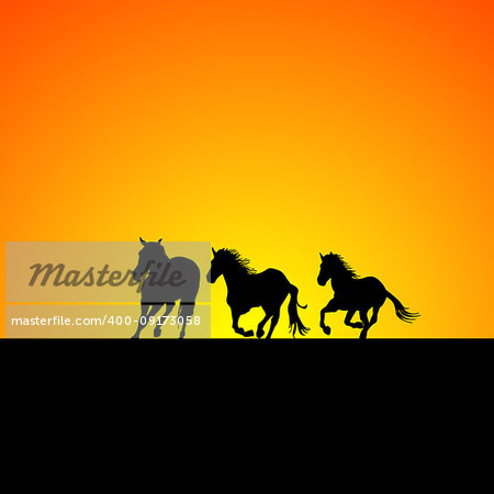 Silhouette of three horses galloping at sunrise