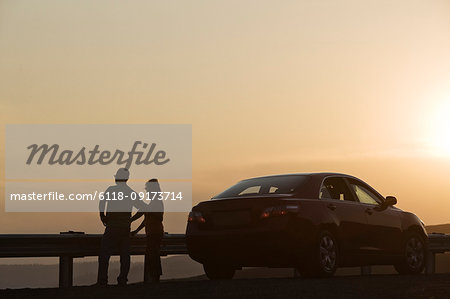 Senior couple watching a sunset from a rest stop on a road trip in eastern Washington State, USA.