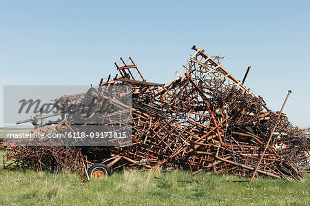 Pile of discarded farming equipment in rural landfill, near Kildeer, Saskatchewan, Canada.