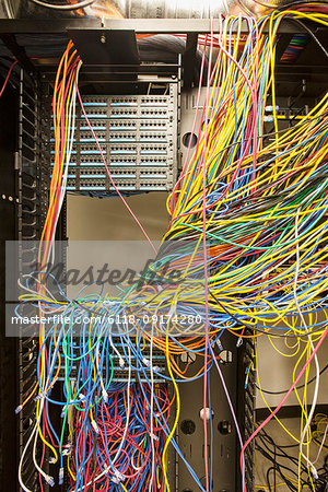 A mess of Cat 5 cables in an office server room.