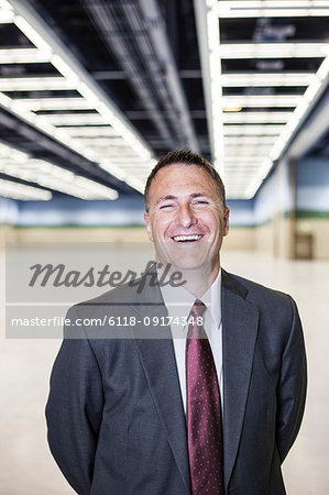 Portrait of a Caucasian businessman in a convention centre space.