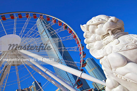 Chinese Guardian Lion with The Hong Kong Observation Wheel and IFC Building, Hong Kong, China, Asia