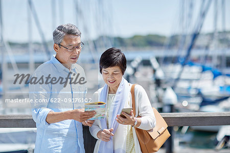 Japanese senior couple having fun by the sea