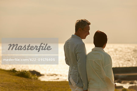 Japanese senior couple having fun by the sea