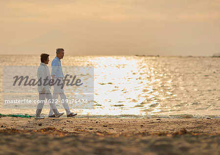 Japanese senior couple having fun by the sea