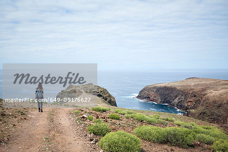 Woman hiking on coastal dirt track, Las Palmas, Gran Canaria, Canary Islands, Spain