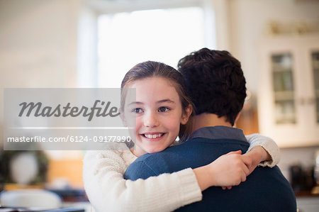 Happy daughter hugging father
