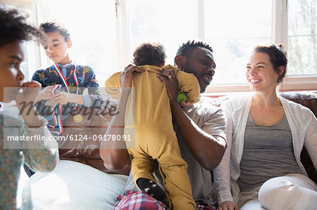 Happy multi-ethnic family on sofa