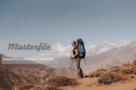 Hiker on peak, Annapurna Circuit, the Himalayas,  Dhaulagiri and Tukuche mountains in background, Muktinath, Nepal