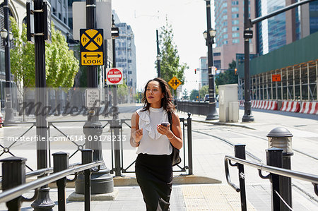 Businesswoman standing by barriers