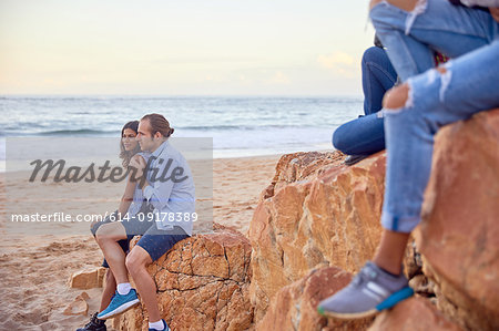 Friends relaxing on beach, Plettenberg Bay, Western Cape, South Africa