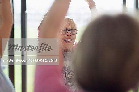 Smiling active senior woman exercising