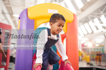 Smiling boy playing on slide