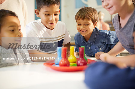 Curious kids watching foam in beakers