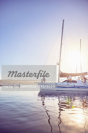 People on boat in sunny harbor