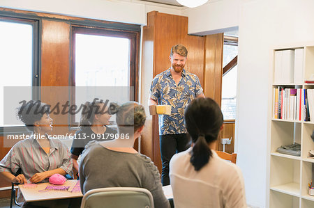 Creative businessman serving coffee and tea to colleagues