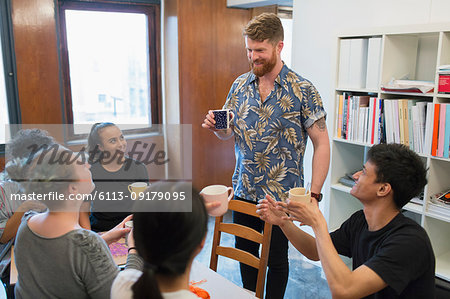 Creative business people enjoying coffee and tea in office Creative business people enjoying coffee and tea in office
