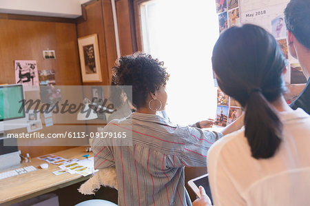 Creative designers reviewing proofs in office