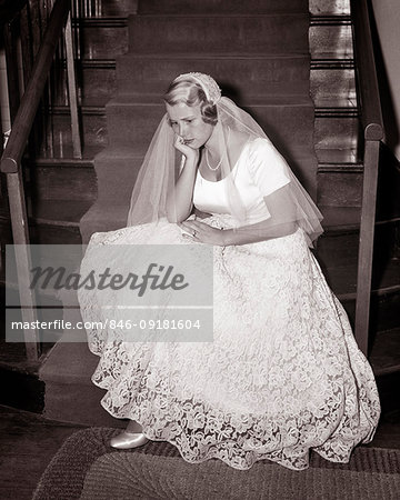 1950s JILTED SAD UNHAPPY BLOND BRIDE WEARING WEDDING DRESS SITTING ON CHURCH STAIRS