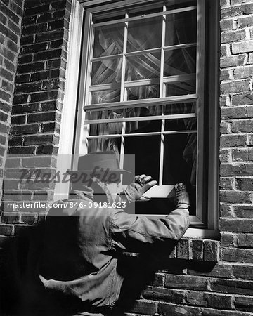 1950s THIEF MAN WEARING HAT GLOVES JACKET BREAKING INTO BRICK HOUSE OPENING WINDOW NIGHTTIME