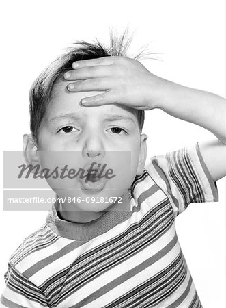 1960s SURPRISED ALARMED BOY WEARING STRIPED T-SHIRT LOOKING AT CAMERA SMACKING FOREHEAD WITH HAND