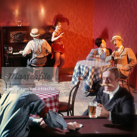 1890s TURN OF THE 20TH CENTURY BAR BEER PARLOR WITH  RAGTIME PIANO PLAYER SALOON SINGER AND PATRONS