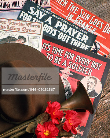 1910s WORLD WAR I STILL LIFE OF POPULAR SHEET MUSIC ARMY CAMPAIGN HAT BRASS BUGLE AND RED-FLOWERED CORN POPPIES Papaver rhoeas