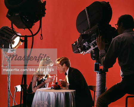 1970s 1980s COUPLE ACTING OUT DATE AT RESTAURANT ON MOVIE STUDIO SET BEING FILMED FOR TELEVISION COMMERCIAL