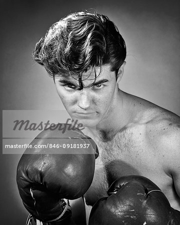 1950s PORTRAIT PRIZE FIGHTER BOXER HAIR FALLING INTO HIS EYES SERIOUS EXPRESSION LOOKING AT CAMERA