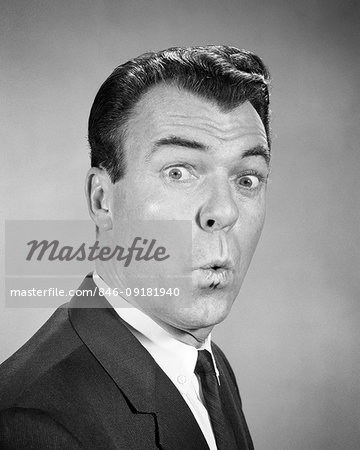 1950s 1960s MAN LOOKING AT CAMERA WITH EYES WIDE LIPS PURSED SURPRISED SHOCKED FACIAL EXPRESSION WHISTLING