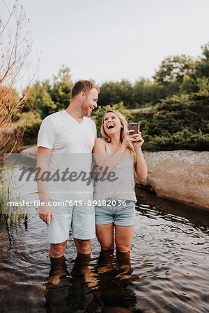 Couple taking selfie in water, Algonquin Park, Canada