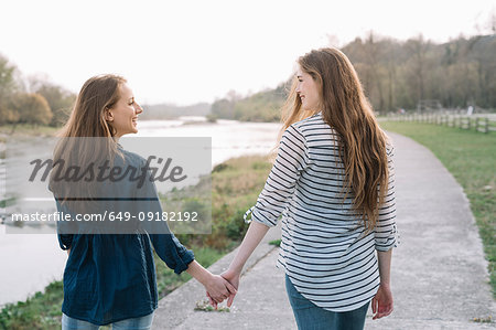 Girlfriends taking walk by river, Belluno, Veneto, Italy