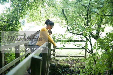 Hiker couple looking over wooden bridge