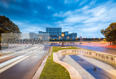 Car light trails at blue hour in front of the huge Palace of Parliament (Palatul Parlamentului), Bucharest, Romania, Europe