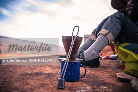 Rock climber making coffee, Desert Towers, Indian Creek, Moab, Utah, USA