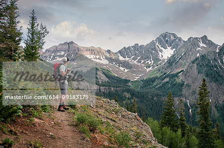 Hiker on mountain peak, Mount Sneffels, Ouray, Colorado, USA