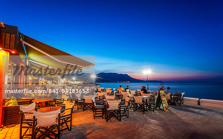 Traditional Cretan Food Restaurant at Paraliaki promenade at sunset in Kissamos, Crete, Greek Islands, Greece, Europe