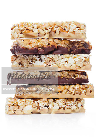 Protein cereal energy bars with nuts and caramel and chocolate for breakfast on white background