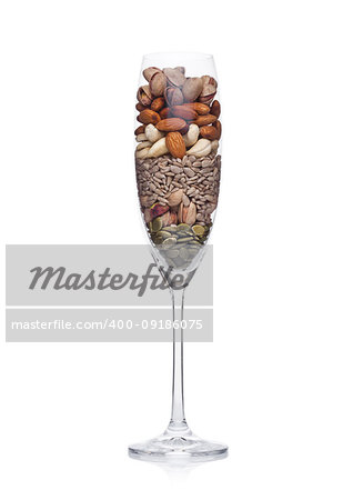 Glass with healthy organic nuts almonds and cashew and pumpkin and sunflower seeds on white background