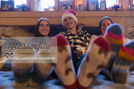 Portrait happy family in colorful socks relaxing in Christmas living room