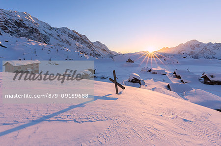 Winter sunset at Alpe Prabello with Mount Disgrazia in the background. Malenco Valley, Valtellina, Lombardy, Italy, Europe