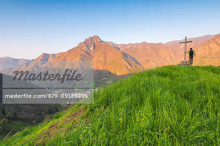 Hiker on the summit of Crocetta, Val Brembana, Orobie alps, Italian alps, Province of Bergamo, Italy